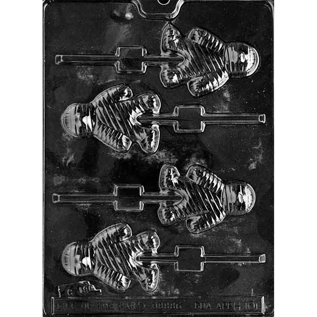 Clear plastic mummy chocolate lollipop mold photographed on a black background, showing four mummy-shaped cavities with raised bandage lines and built-in stick grooves.