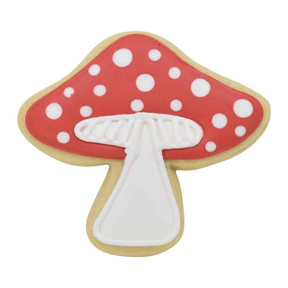 Decorated mushroom-shaped cookie with a red cap, white polka dots, and a detailed stem.