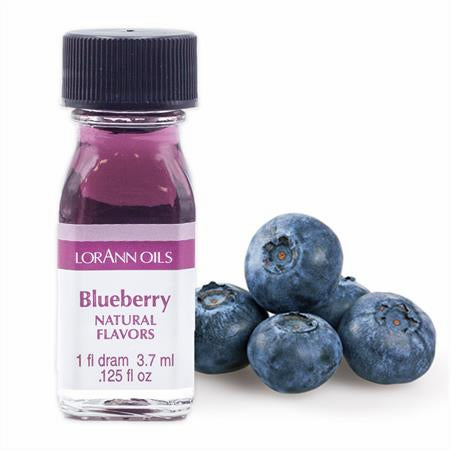 Clear 1-dram bottle of LorAnn Blueberry Natural Flavoring filled with purple liquid and displayed beside fresh blueberries.