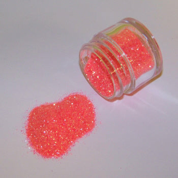 Neon coral-pink Galaxy Glitter Dust pouring from a jar, glowing with bright, tropical sparkle and golden highlights.