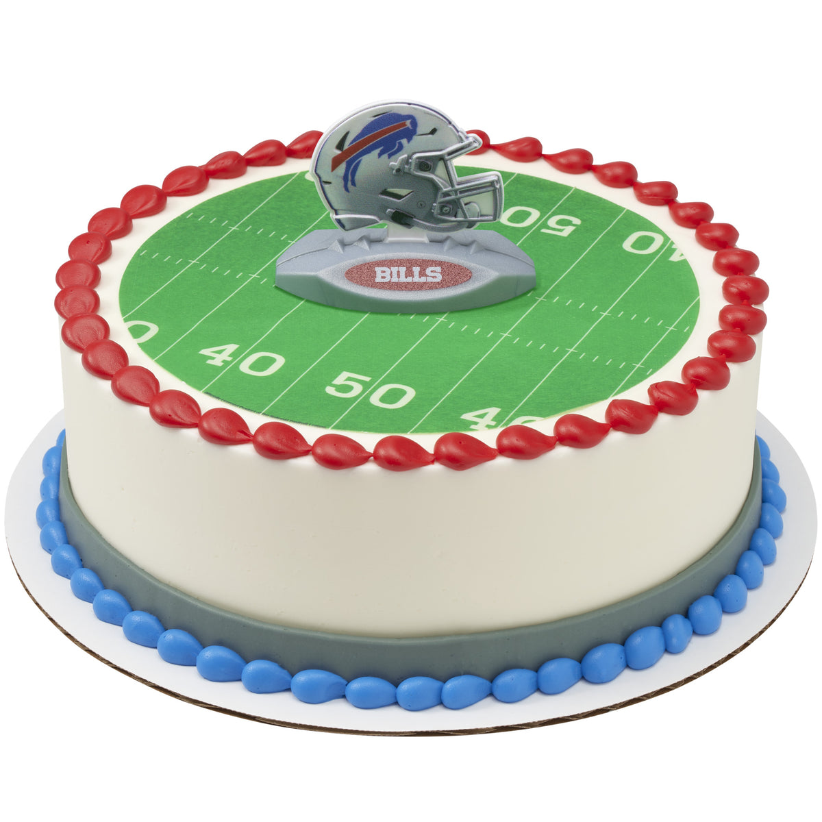 A round cake decorated with a green football field print, red piped border, blue base, and a silver charging buffalo helmet topper on a white background.