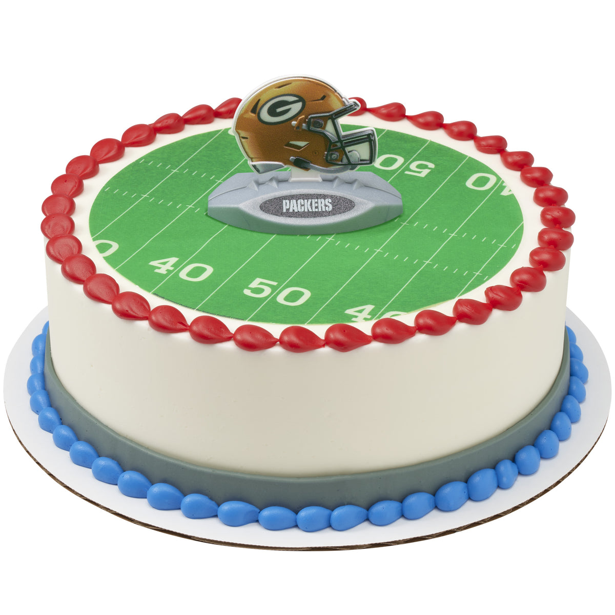 A round cake decorated with a green football field print, red piped border, blue base trim, and a Packers helmet topper on top.