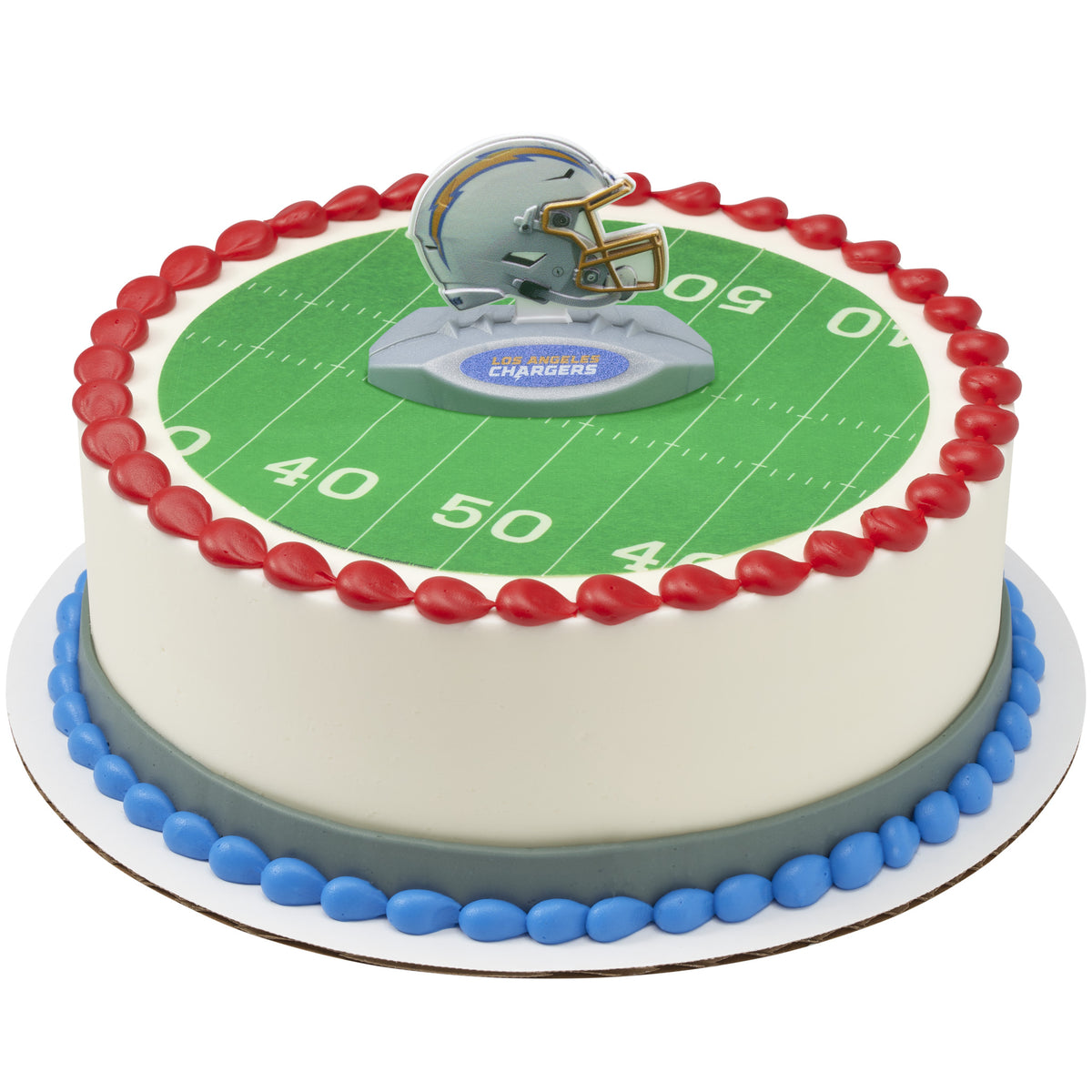 A round cake decorated with a green football field graphic, red piped border, blue base trim, and a Chargers helmet topper on top.