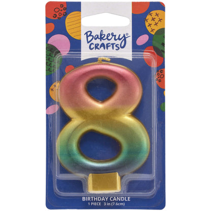 Packaged metallic rainbow number 8 birthday candle with a pink-to-gold-to-green-to-blue gradient and a gold base, on a blue Bakery Crafts card.
