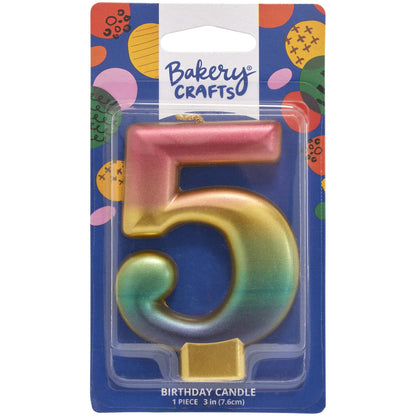 Packaged metallic rainbow number 5 birthday candle with a pink-to-gold-to-green-to-blue gradient and a gold base, on a blue Bakery Crafts card.