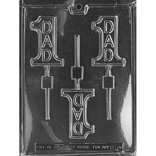 Clear plastic chocolate lollipop mold with three cavities shaped like a number 1 and the word “DAD” inside, plus lollipop stick channels, shown on a dark background.
