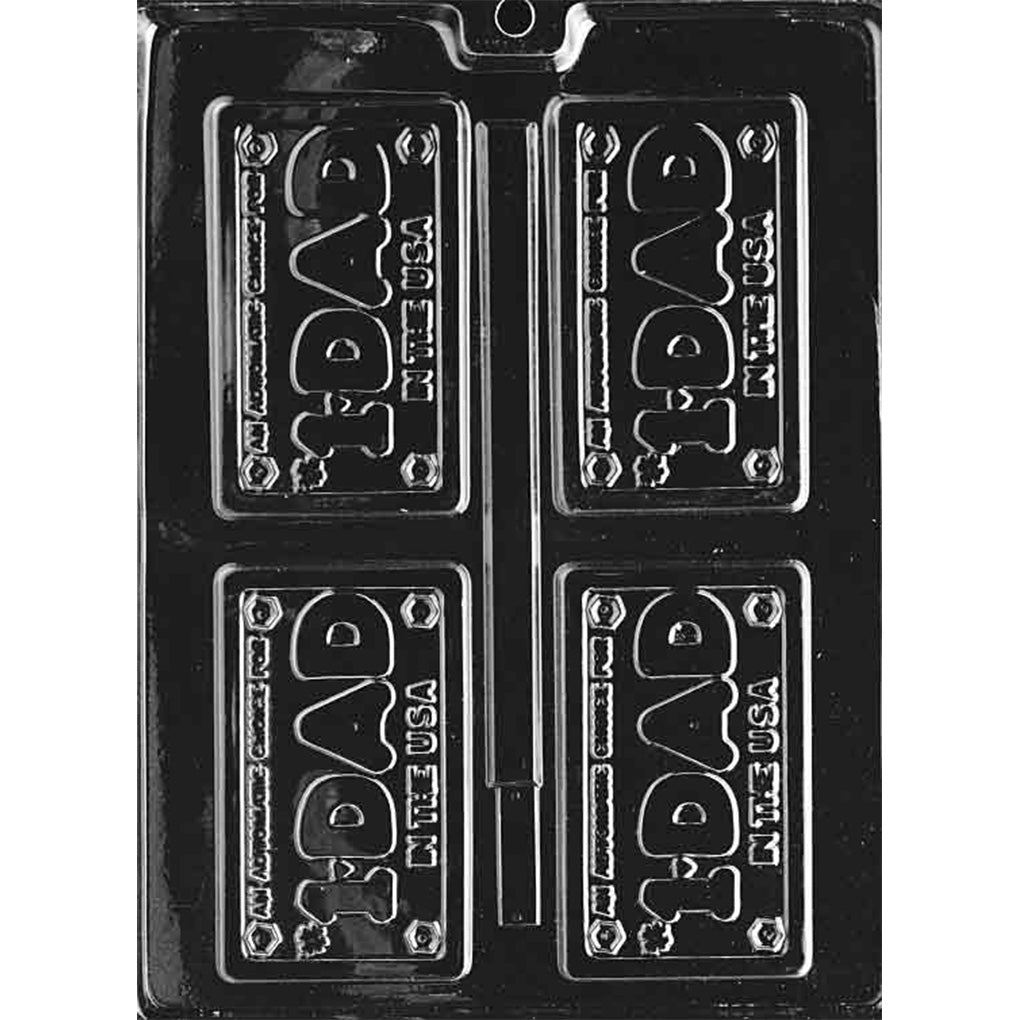 Clear plastic chocolate mold with four license plate–style cavities reading “#1 Dad in the USA,” featuring raised lettering and small bolt details in each corner.