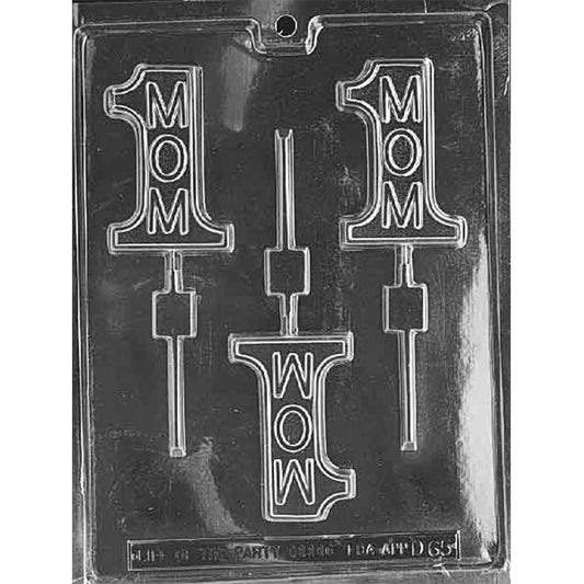 Clear plastic chocolate lollipop mold with three cavities shaped like a number 1 and the word “MOM” inside, plus lollipop stick channels, shown on a dark background.