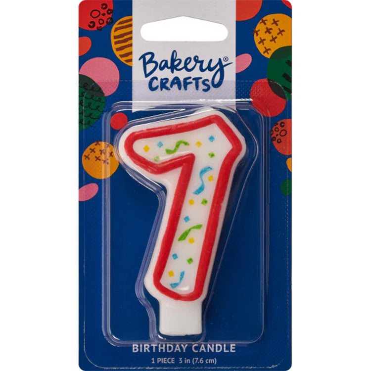 Packaged number 7 birthday candle with a white center, red outline, and multicolor confetti sprinkles on a blue Bakery Crafts card.