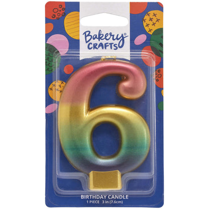 Packaged metallic rainbow number 6 birthday candle with a pink-to-gold-to-green-to-blue gradient and a gold base, on a blue Bakery Crafts card.