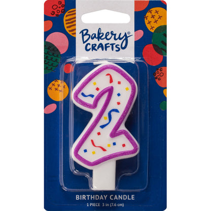 Packaged number 2 birthday candle with a purple outline and colorful confetti center on a blue Bakery Crafts backing card with multicolor dots.