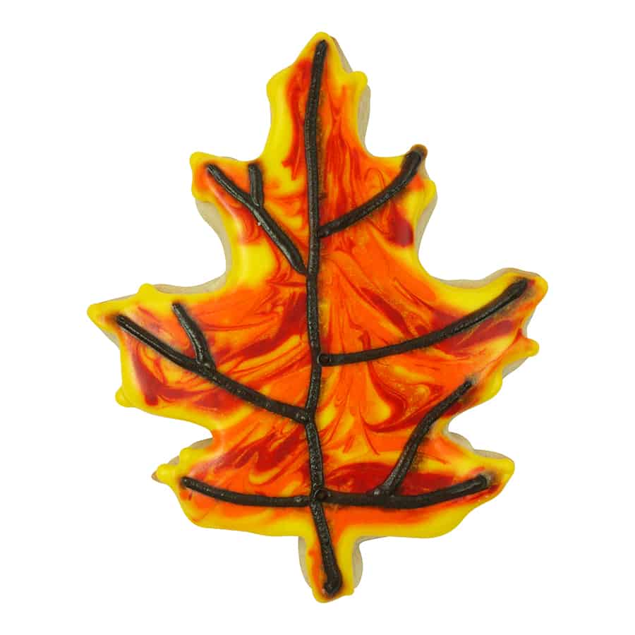 Decorated oak leaf cookie with marbled orange and yellow icing, accented with black piped veins.