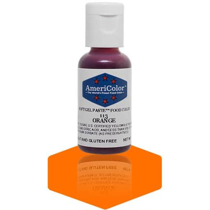 A bottle of AmeriColor Orange soft gel paste food coloring, showcasing a white cap, blue label with red stars, and placed on a glossy orange surface with its reflection visible.