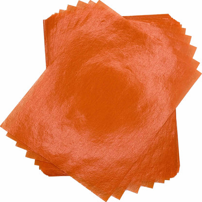 Overlapping stack of bright orange 4" x 5" wax caramel and taffy wrapper sheets displayed against a white background.