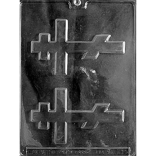 Clear plastic chocolate mold with two Orthodox cross-shaped cavities featuring a long vertical bar, crossbar, and slanted footrest detail, shown on a dark background.