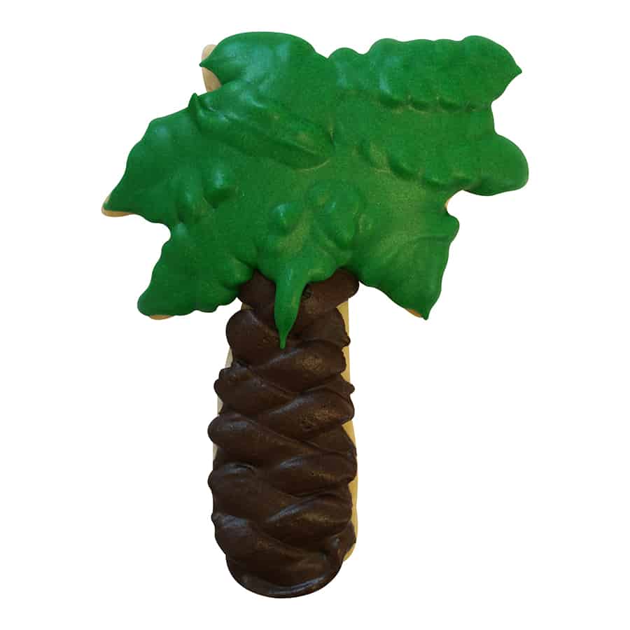 Palm tree-shaped cookie with detailed green icing leaves and a textured chocolate brown trunk.