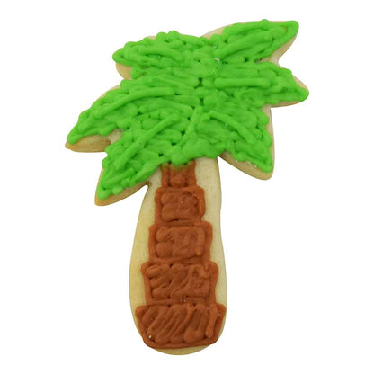 Decorated palm tree cookie with green icing fronds and a brown trunk.