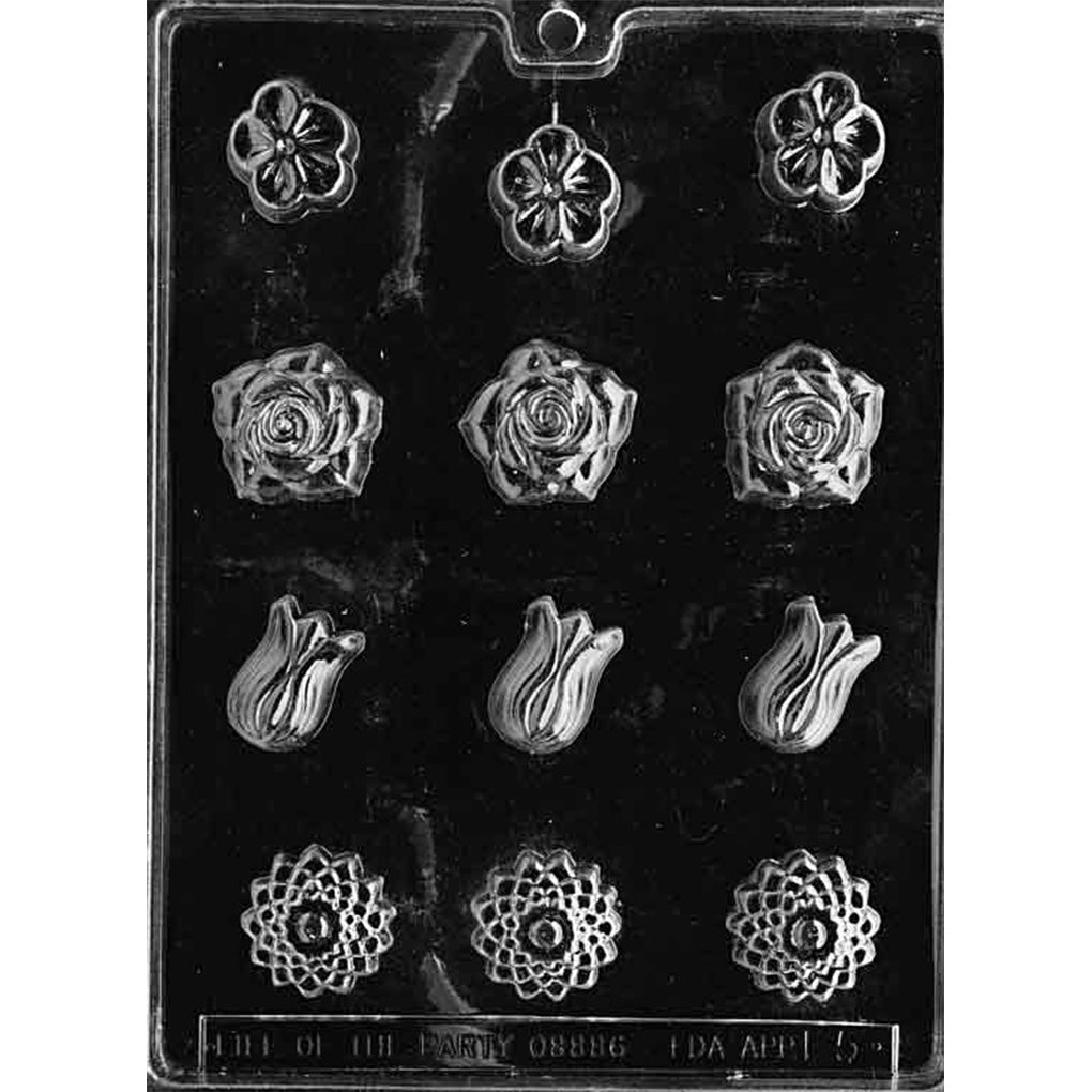 Clear plastic chocolate mold with twelve small flower cavities in four styles, including pansy blossoms, spiral roses, tulip buds, and detailed dahlia flowers.