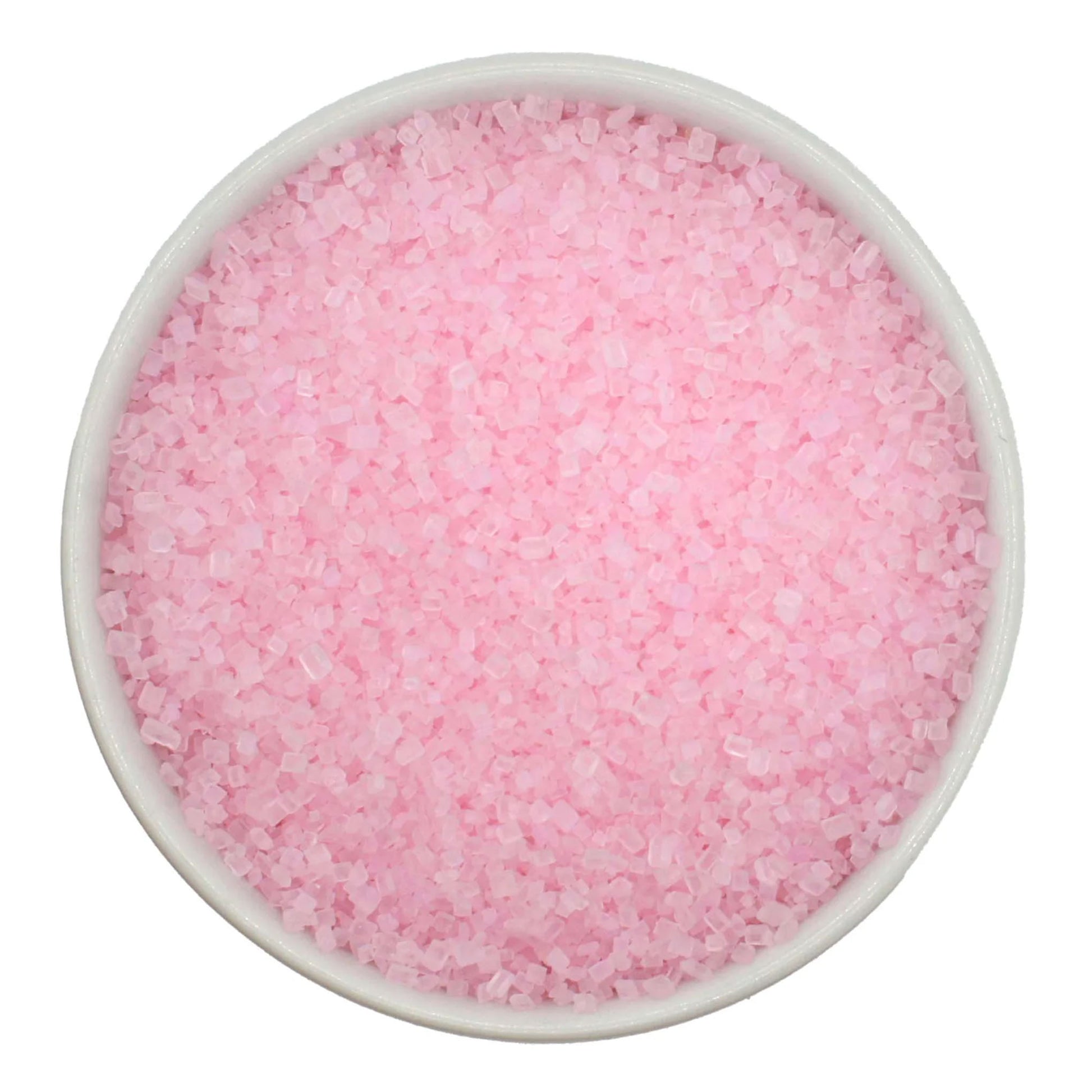 Top-down view of a white bowl filled with pastel pink coarse sanding sugar crystals, showing chunky sparkling granules in a soft blush-pink color.