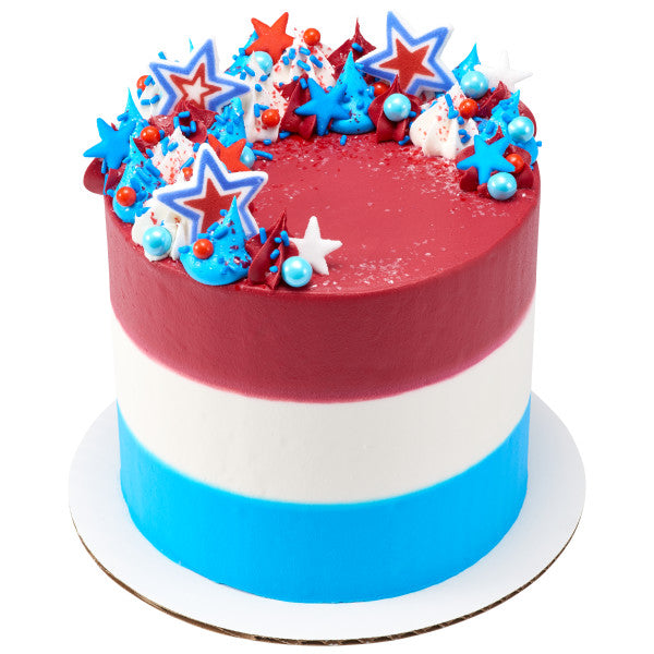 Red, white, and blue cake topped with patriotic star sugar decorations and colorful frosting.