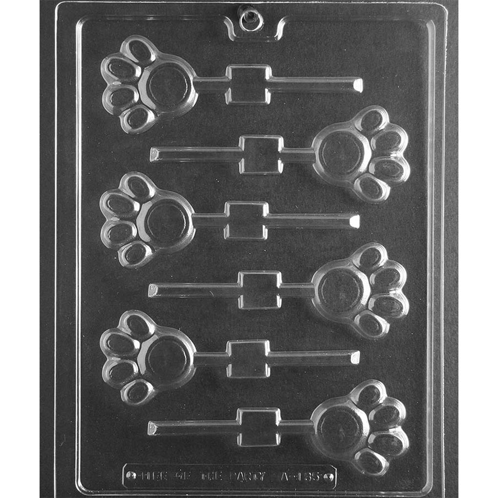 Clear plastic chocolate lollipop mold with six paw print cavities, each sized about 2 inches, designed for making paw-shaped chocolate pops.