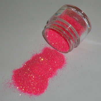 Peach Galaxy Glitter Dust spilling from a jar, bursting with bold electric shimmer and flecks of gold sparkle.