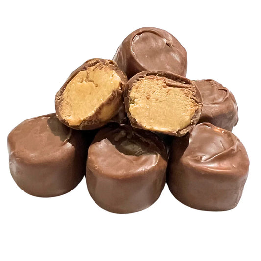 Stack of peanut butter-filled chocolate candies, with two cut open to show the creamy peanut butter center.
