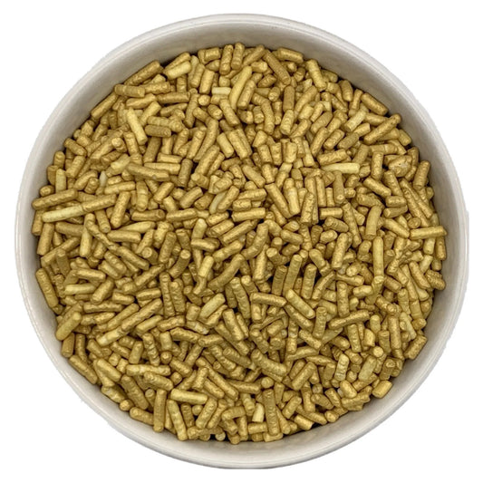 White bowl filled with pearlized gold jimmies sprinkles, showing small cylindrical pieces with a shimmering metallic finish on a white background.