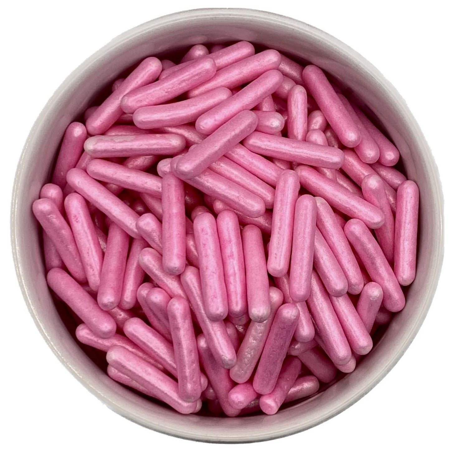 Bright pink pearlized edible rod sprinkles in a white bowl, showcasing their oversized length and smooth texture, perfect for bold dessert accents.