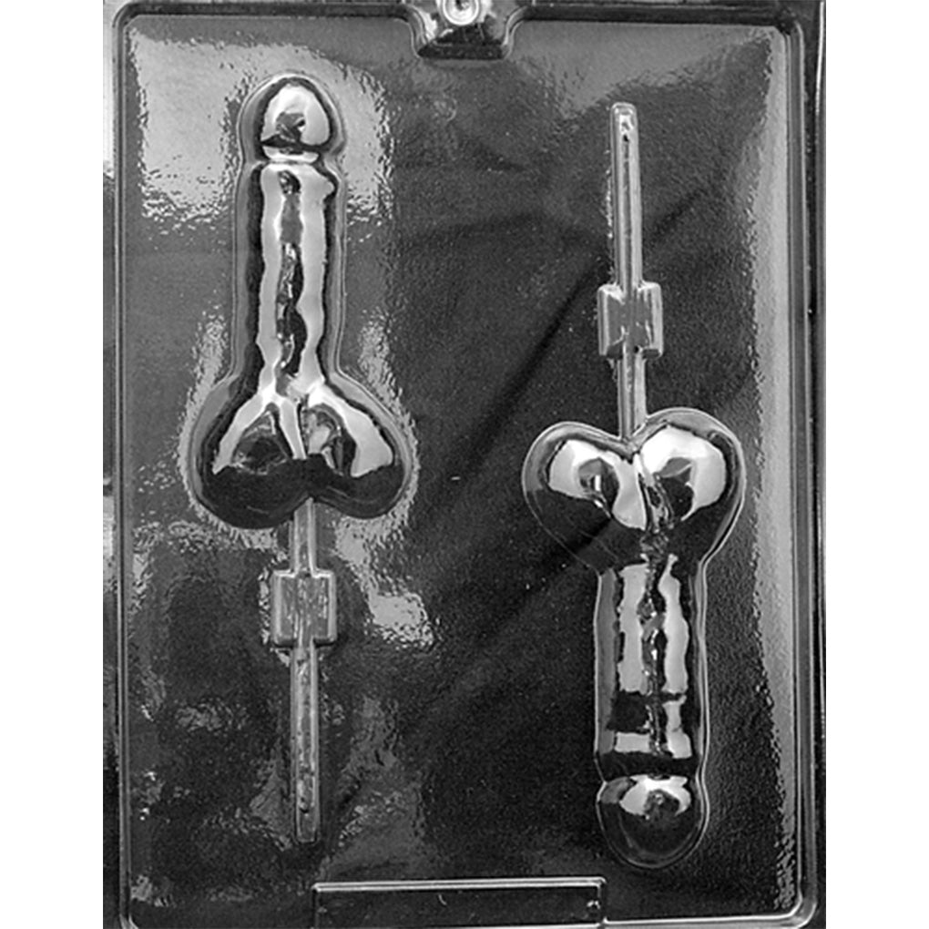 Clear plastic Penis Chocolate Lollipop Mold photographed against a dark background, featuring two penis-shaped cavities with rounded tips, testicles, molded details, and channels for lollipop sticks.