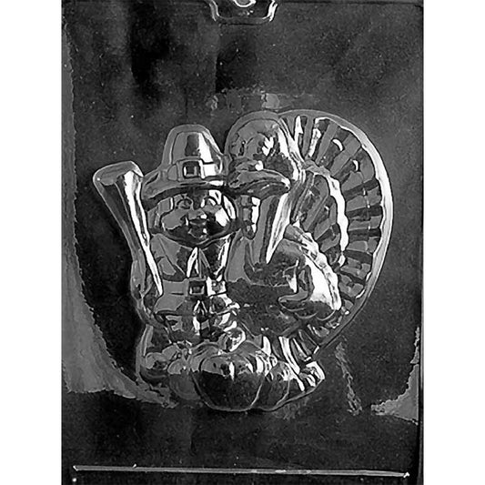 Clear Pilgrim Hunter & Turkey Chocolate Mold photographed against a black background with one large Thanksgiving scene featuring a Pilgrim hunter, full-feathered turkey, pumpkins, and harvest details.