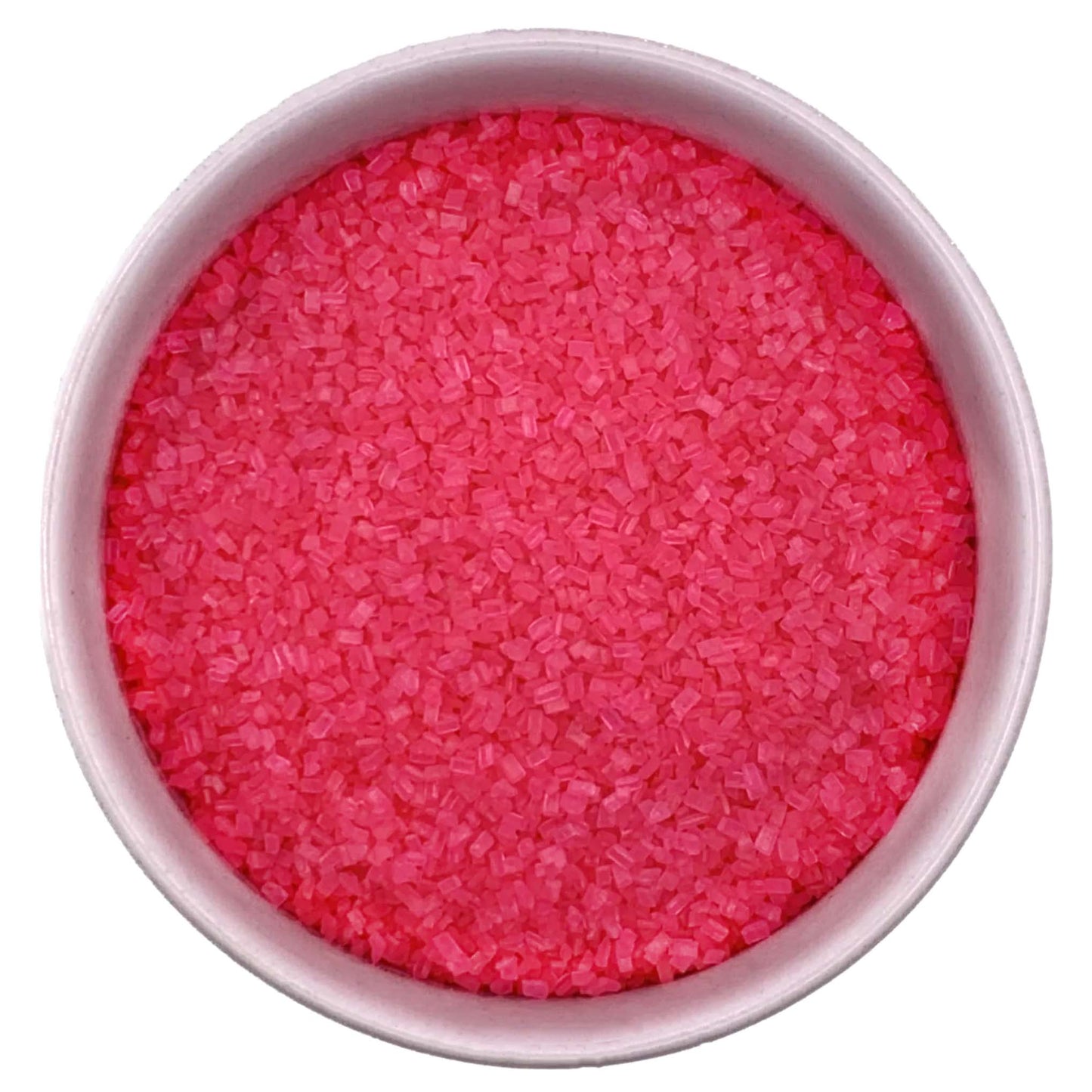 Top-down view of a white bowl filled with bright pink coarse sanding sugar crystals, showing chunky sparkling granules and a vivid candy-pink color.