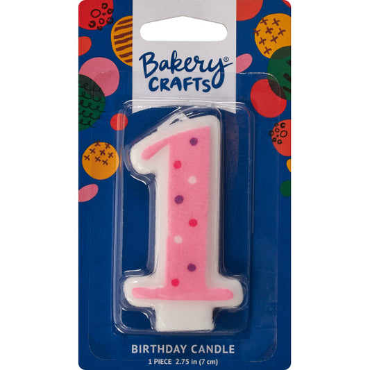 Pink number 1 birthday candle with white and dark pink polka dots in packaging, perfect for a first birthday celebration.
