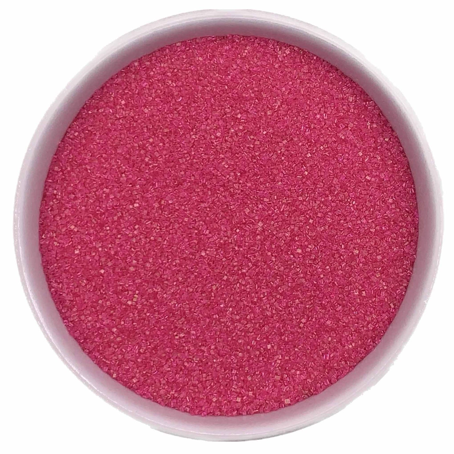 Top-down view of a white bowl filled with bright pink fine sanding sugar, showing tiny sparkling crystals in a vivid rosy-pink shade.