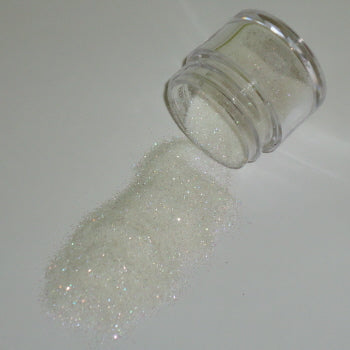 Iridescent white Galaxy Glitter Dust poured from a jar, featuring soft shimmer with rainbow reflections and a snowy appearance.