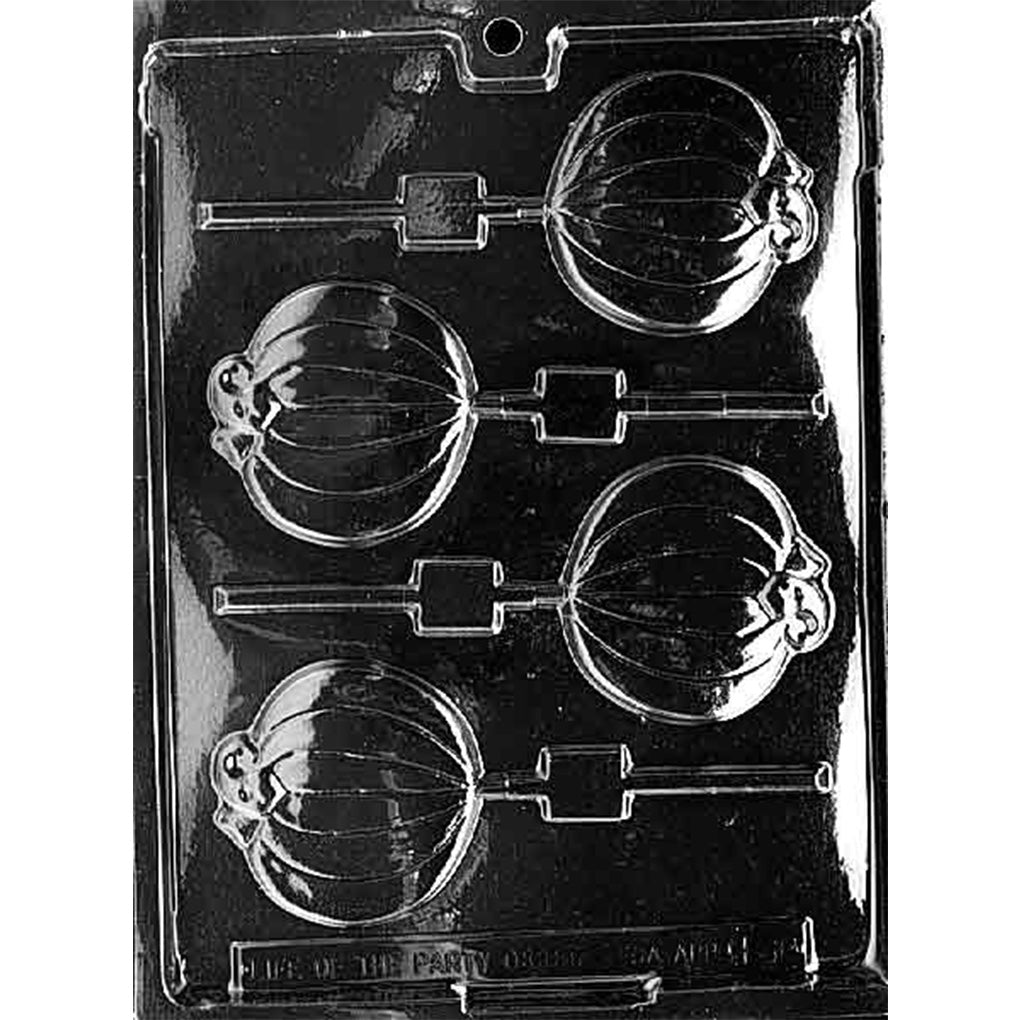 Clear plastic chocolate lollipop mold with four pumpkin-shaped cavities on sticks, shown on a dark background with a smooth, flat pumpkin design.