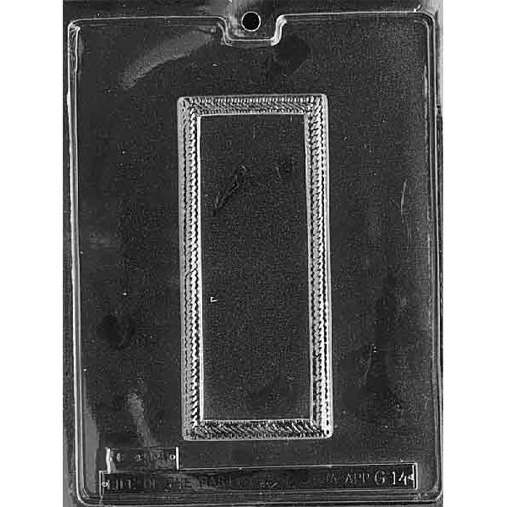 Single-cavity chocolate bar mold with a 7 x 3-inch rectangular plaque, raised scrollwork border, blank center, and 3/8-inch depth.