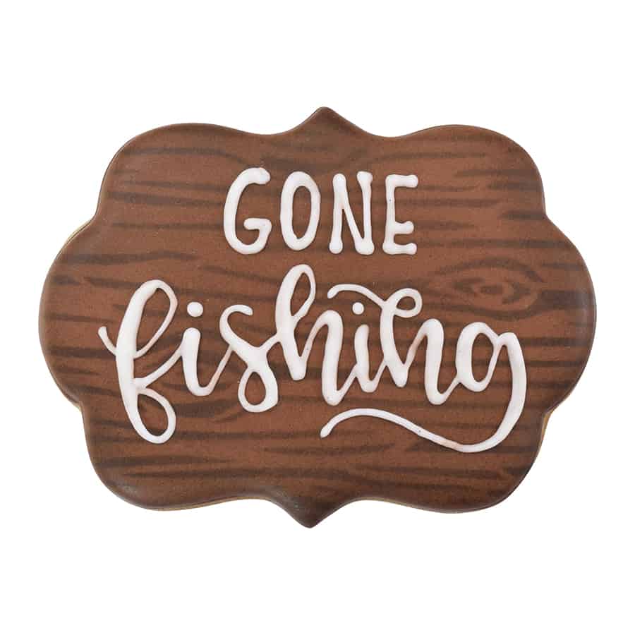 Decorated plaque cookie with woodgrain icing and "Gone Fishing" message.