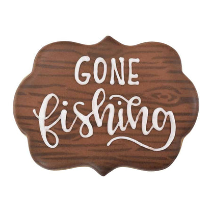 Decorated plaque cookie with woodgrain icing and "Gone Fishing" message.