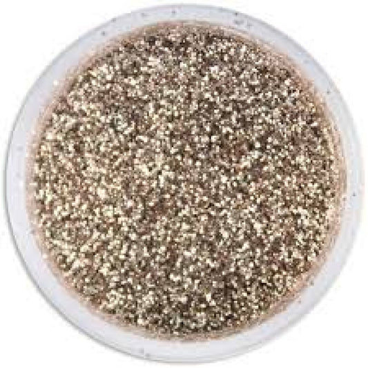 Top-down view of a small clear round container filled with platinum-silver glitter dust, showing dense reflective sparkle across the surface.