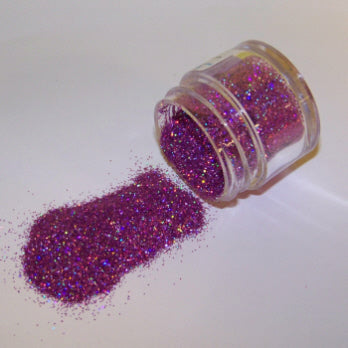 Bright violet Galaxy Glitter Dust spilling from a jar, catching the light with multicolored reflections and vibrant purple tones.