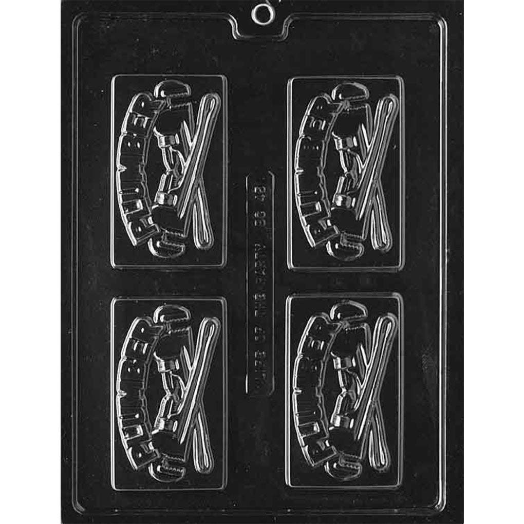 Clear plastic chocolate bar mold photographed on a black background with four rectangular cavities, each showing a raised plumber design with crossed wrenches and the word “Plumber.”