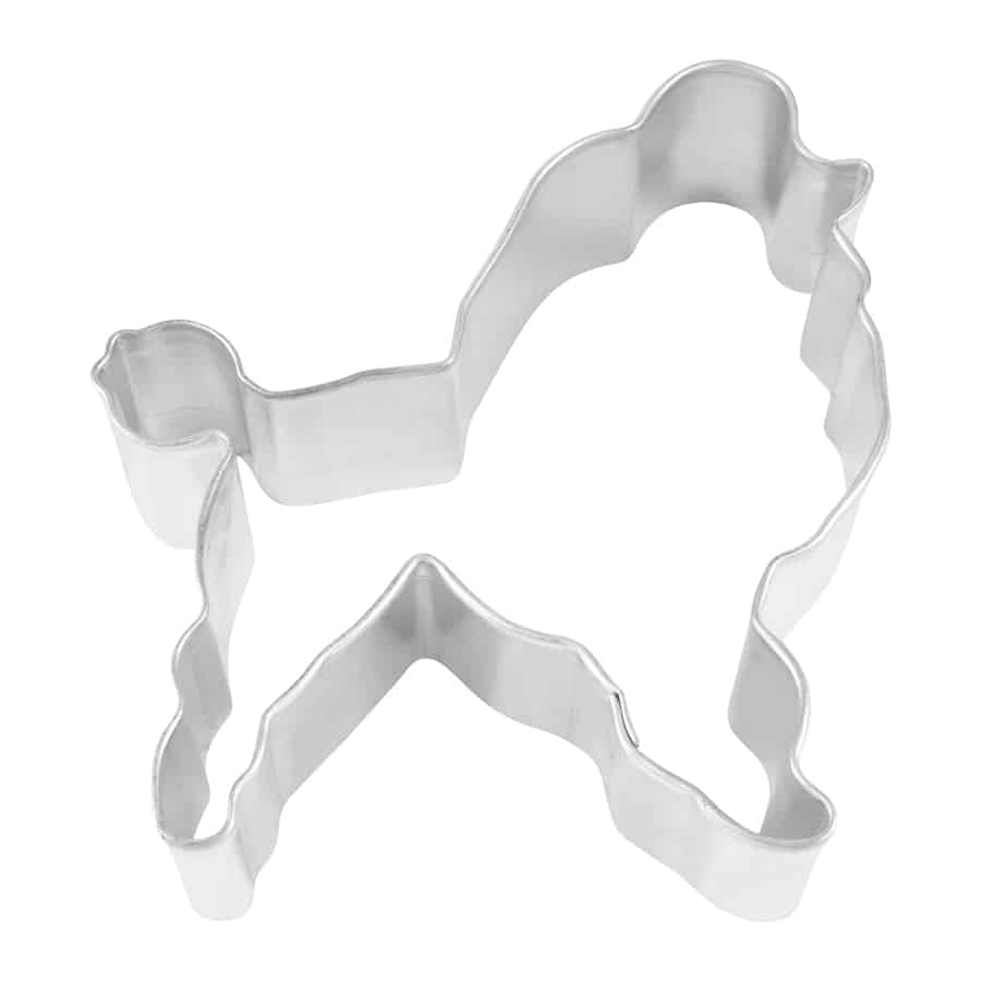 Metal poodle-shaped cookie cutter with intricate detailing, photographed from a top-down angle.