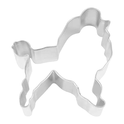 Metal poodle-shaped cookie cutter with intricate detailing, photographed from a top-down angle.