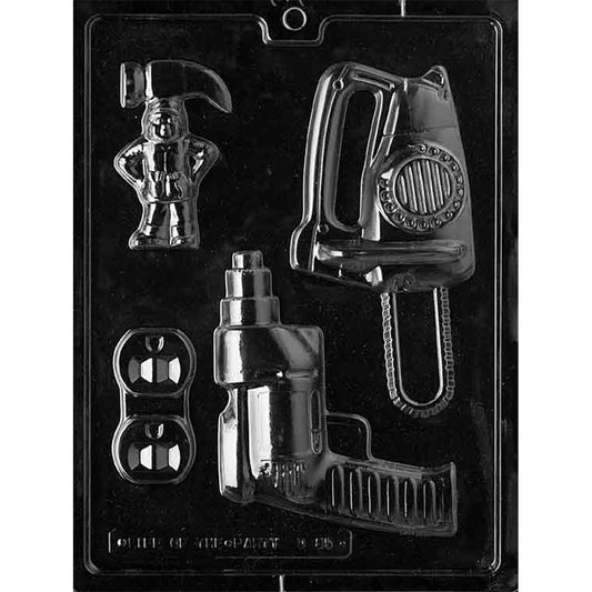 Clear plastic chocolate mold with a large circular saw cavity, a cordless drill cavity, a small hard hat figure cavity, and two mini dumbbell cavities arranged on one tray.