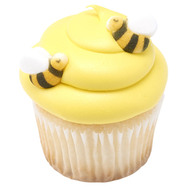 Yellow frosted cupcake topped with two pressed sugar bumble bee decorations