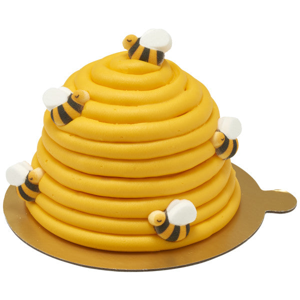 Beehive-shaped cake decorated with multiple bumble bee sugar toppers
