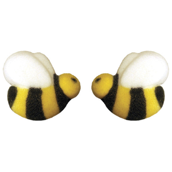 Pressed sugar decorations shaped like bumble bees with black and yellow stripes and white wings