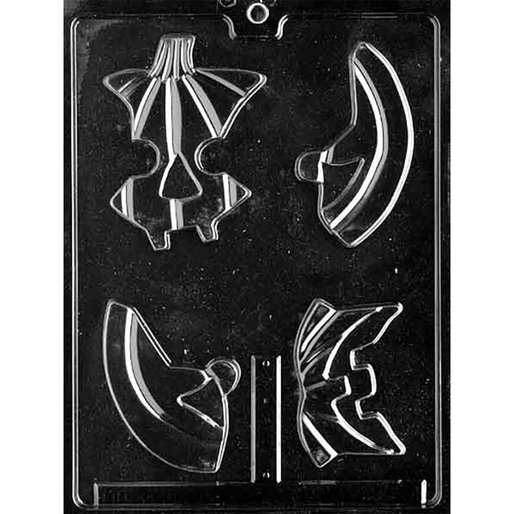 Clear plastic chocolate mold with four separate puzzle-piece cavities that assemble into a pumpkin design, shown on a dark background.