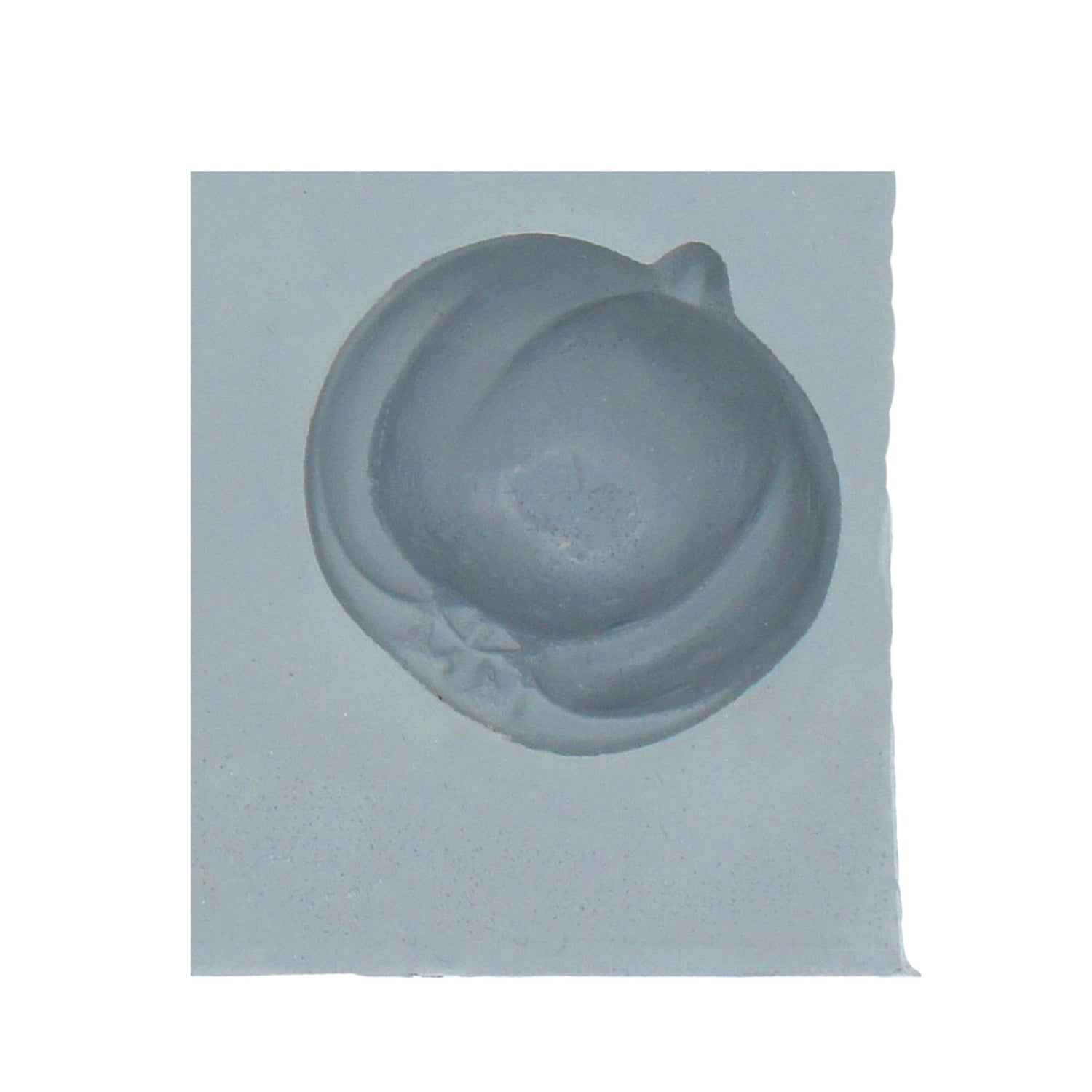 Close-up of a rubber mint mold featuring a rounded fruit shape, suitable for apple or pumpkin-themed treats.